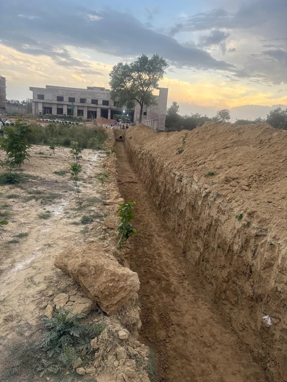 Excavated drainage trench at sunset