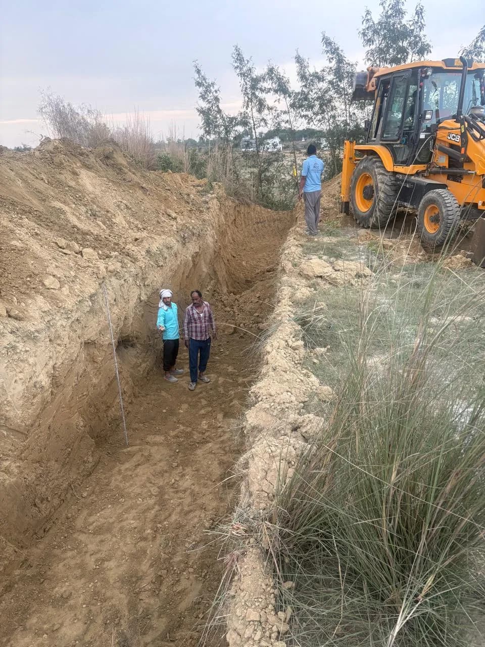 Supervisors inspecting a deep excavated trench