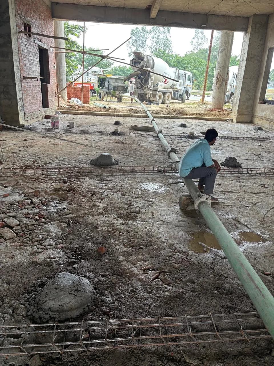 Concrete pump line across the prepared floor