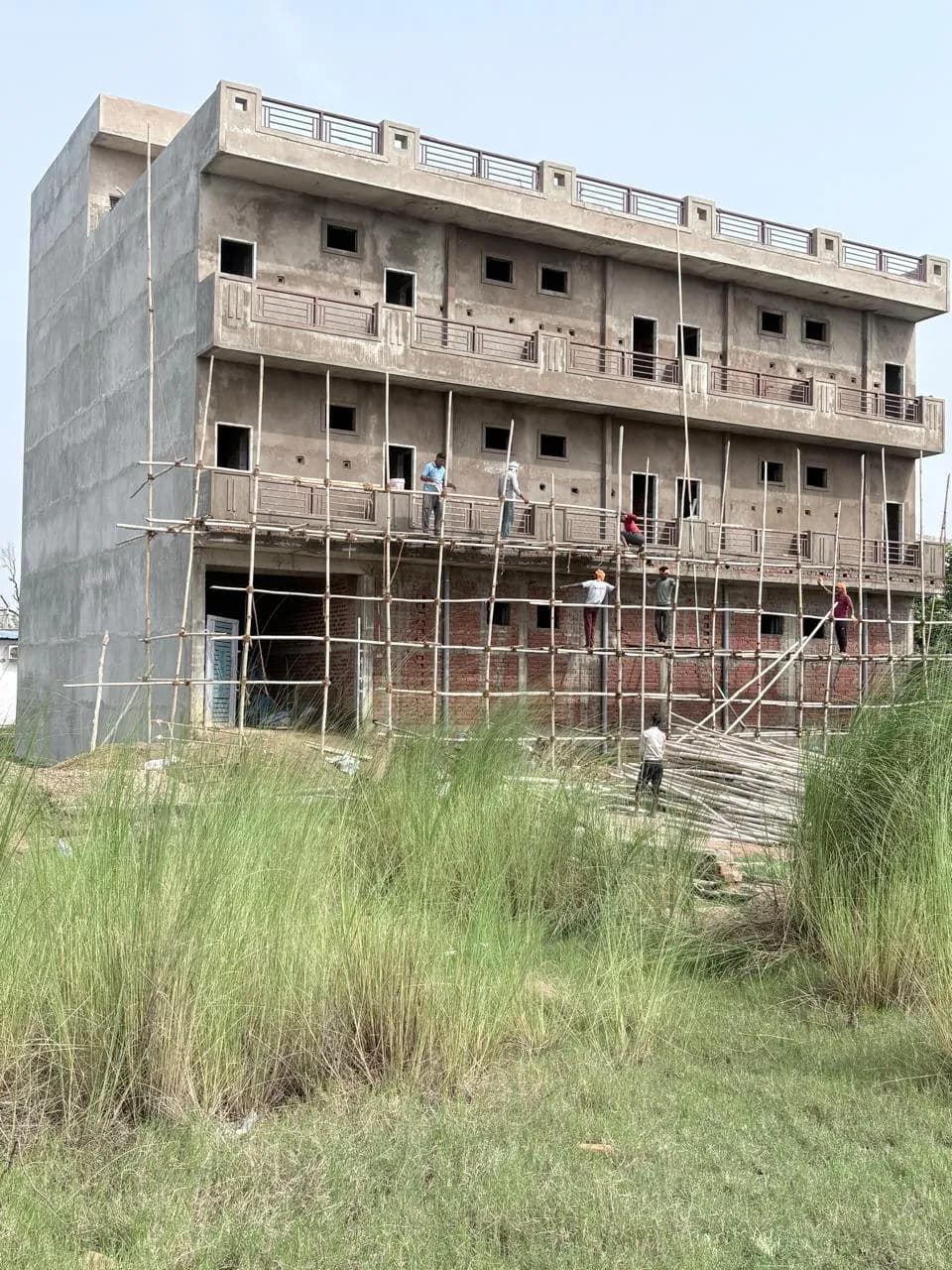 Four-storey building with brick lower floors and plastered upper floors