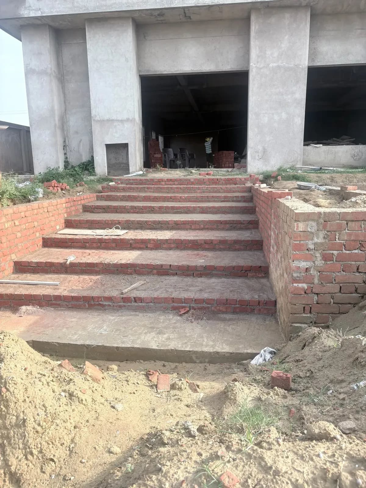 Brick entrance steps with side walls under construction
