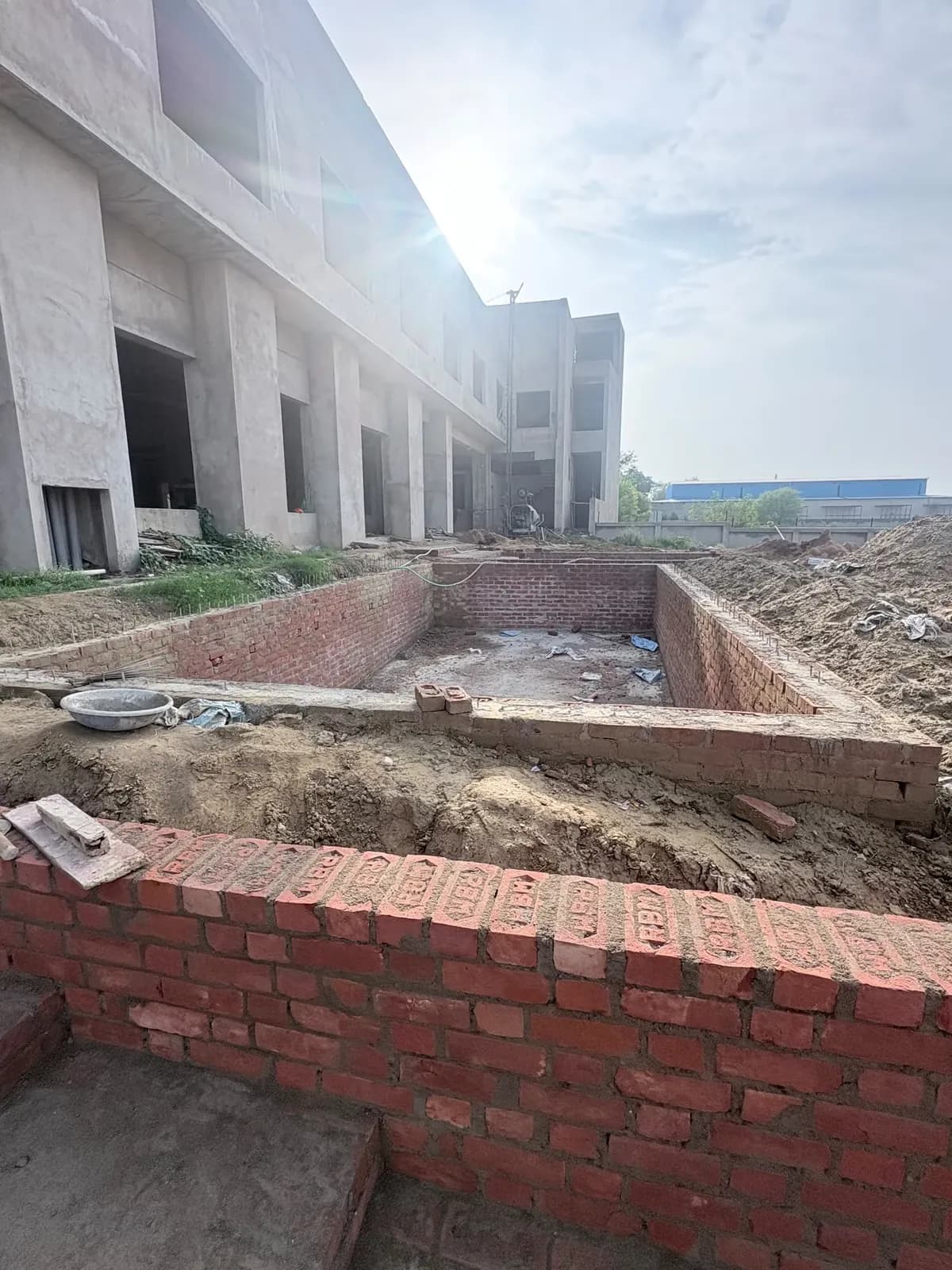 Brick boundary works alongside the building