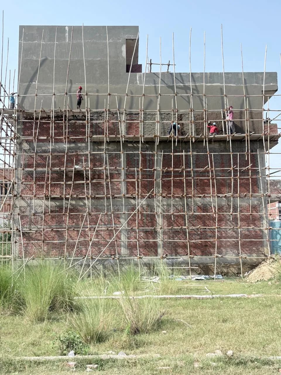 Block building with plaster applied at the top