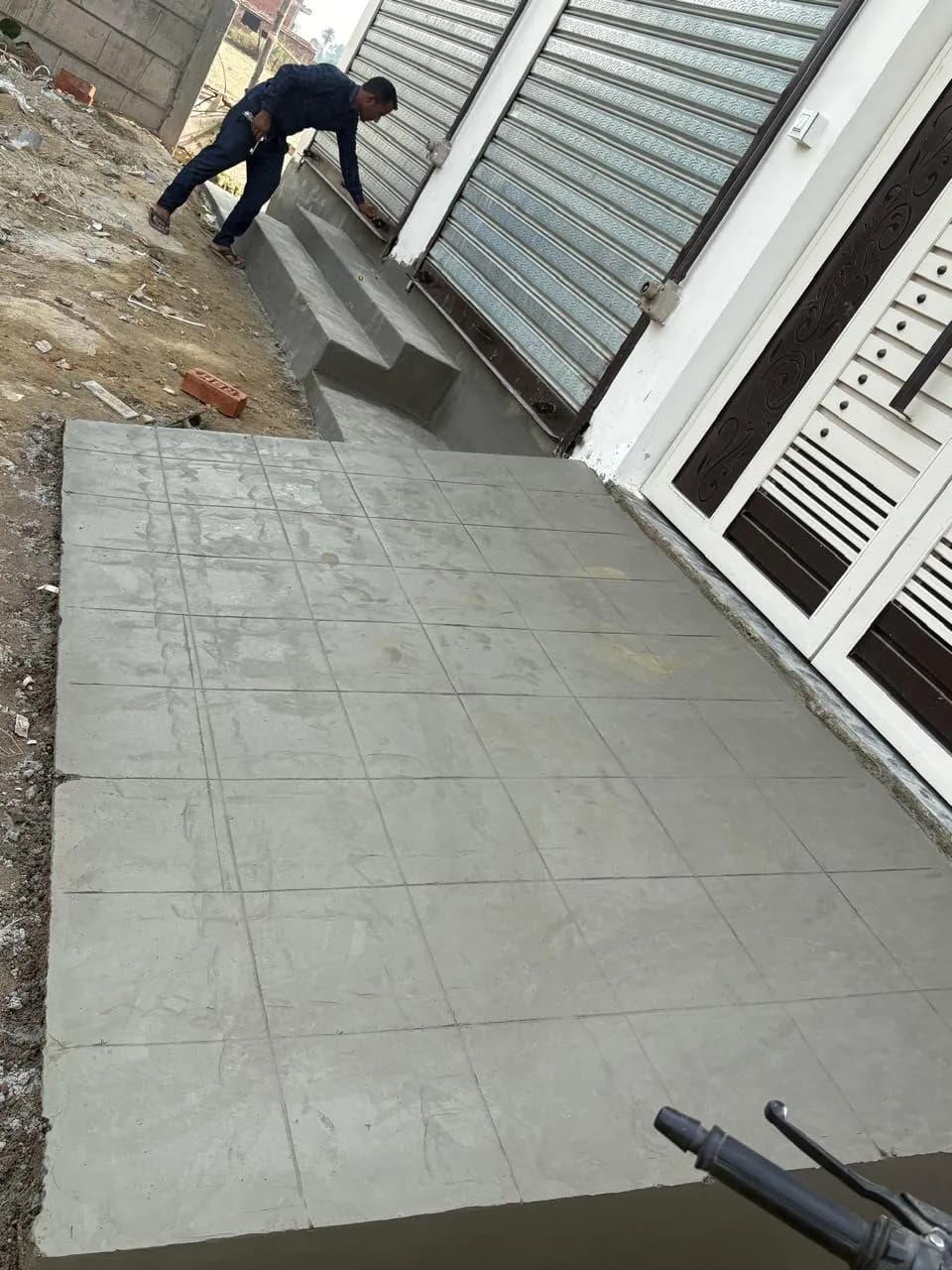 Finishing the concrete ramp in front of the entrance