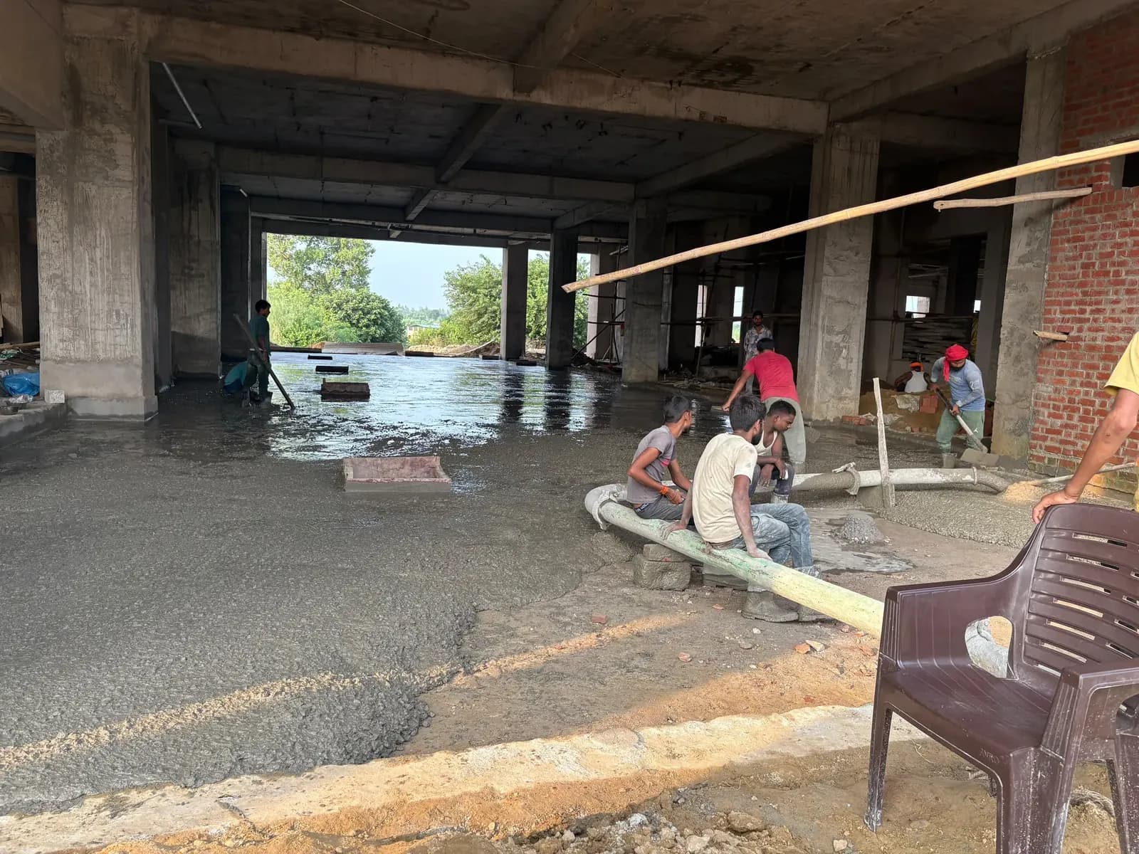 Concrete being placed across a large column hall